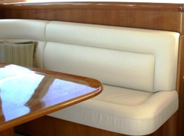 Custom cream saloon seating beside a polished timber table